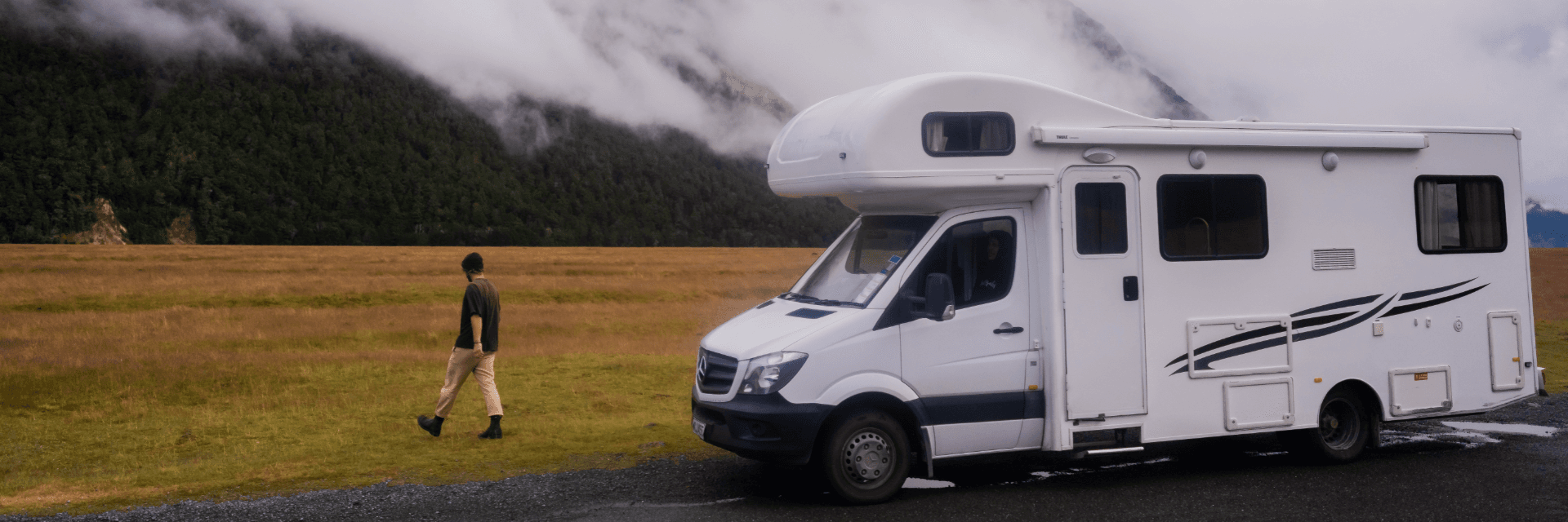 6 berth man walking in field (1920 x 640 px)